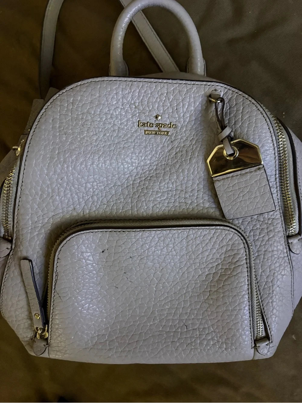 kate spade Pebbled Leather Mini Backpack in Off-White with Gold Hardware